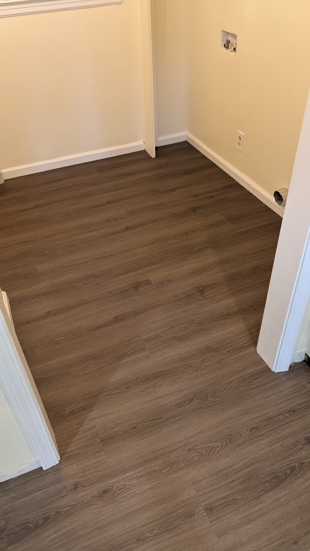 Room with newly installed wood-look plank flooring