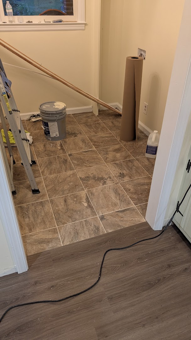 Room with old square tile flooring before replacement